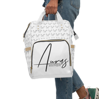 Mockup picture of Chic white diaper bag by Auras Boutique featuring our logo throughout. Gold zippers & khaki trim add a touch of luxury.