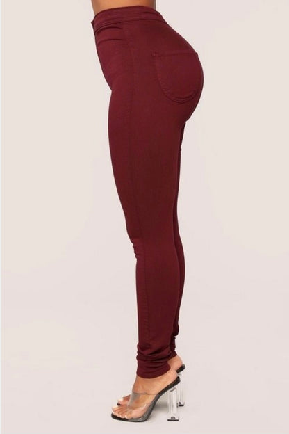 Burgundy Bliss: Side view of burgundy denim jeans on model.