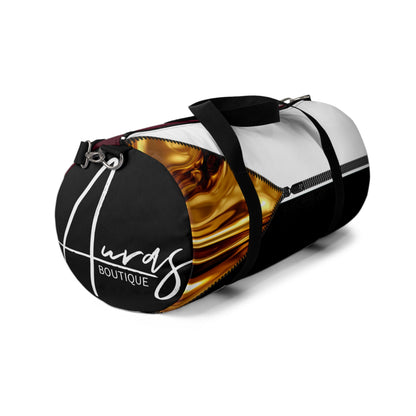 LUXE-Duffel: Left side view of black bag with gold texture print over merlot and white.