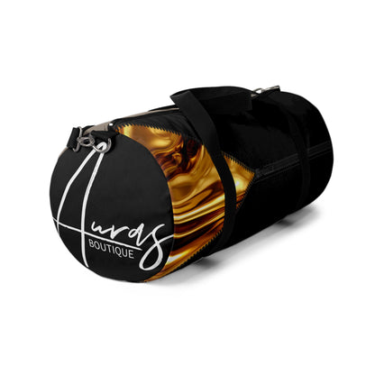 LUXE-Duffel: Left side view of black bag with gold texture print over khaki and black.