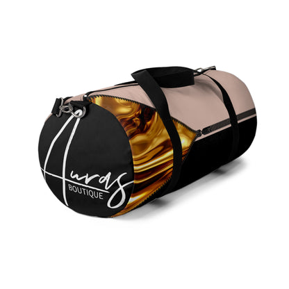 LUXE-Duffel: Left side view of black bag with gold texture print over coral and coral.